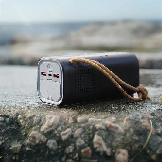 Black battery emergency power bank with solar panel, 70mm by 70mm by 162mm, showing 200W output and charging ports