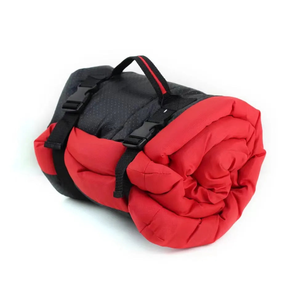 Blue foldable outdoor dog bed shown both open and folded with nylon buckles, on a grassy background.