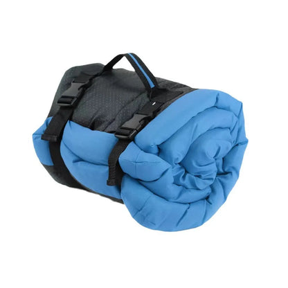 Blue foldable outdoor dog bed shown both open and folded with nylon buckles, on a grassy background.