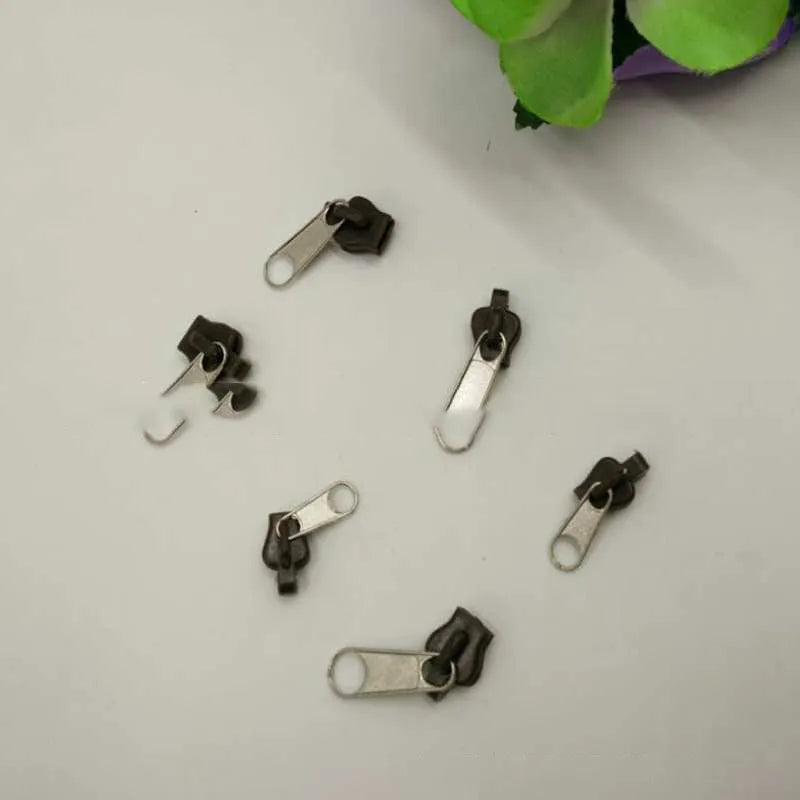 12-piece zipper head repair kit with plastic and metal replacement pulls in brown, black, and half-black colours