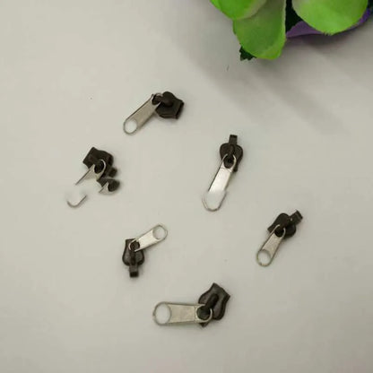 12-piece zipper head repair kit with plastic and metal replacement pulls in brown, black, and half-black colours