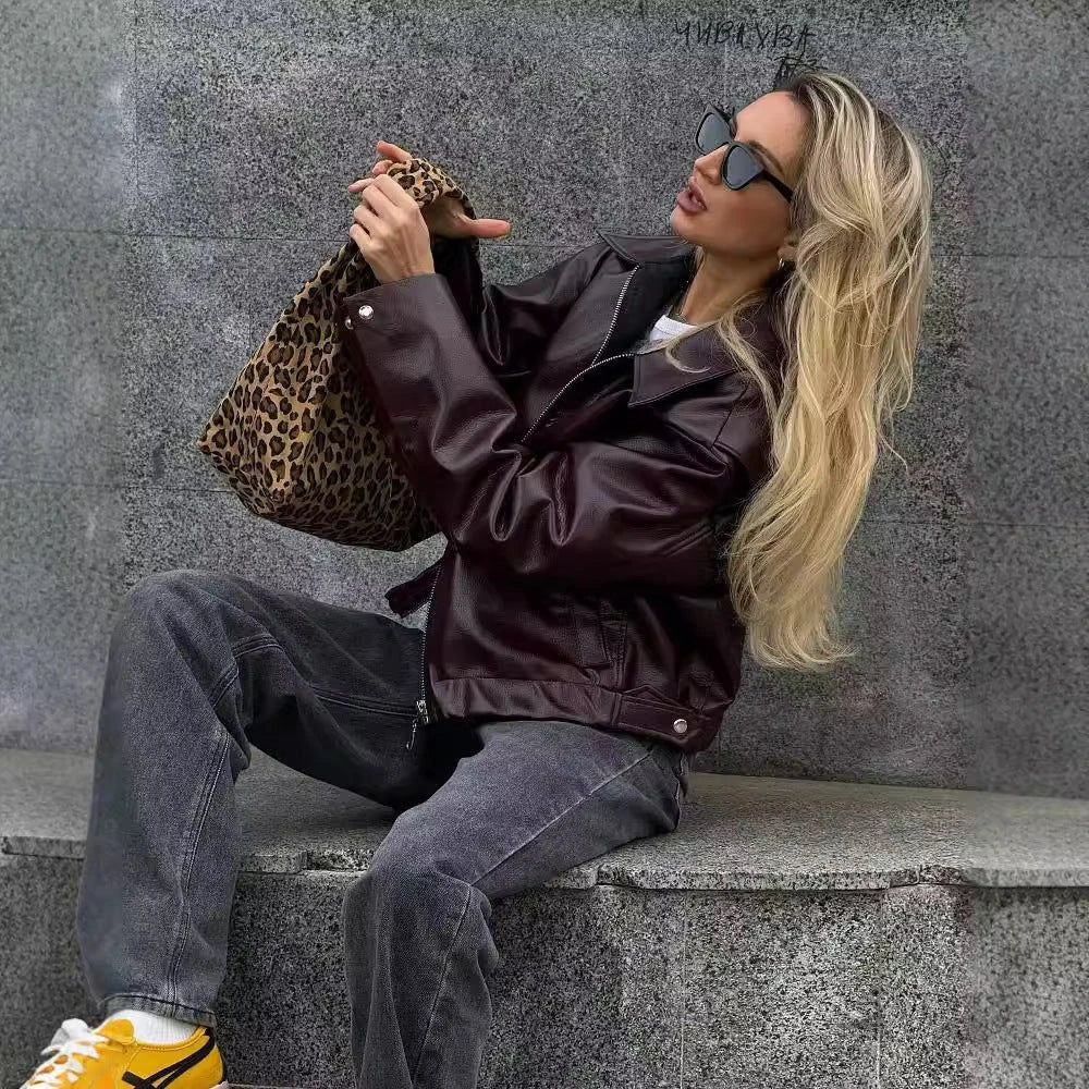 Stylish faux leather jacket with zip-up closure and lapel collar, available in burgundy and black colors