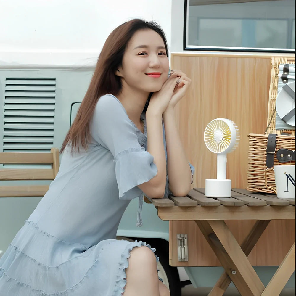 Blue shaking head handheld fan showing oscillating mechanism and USB charging port