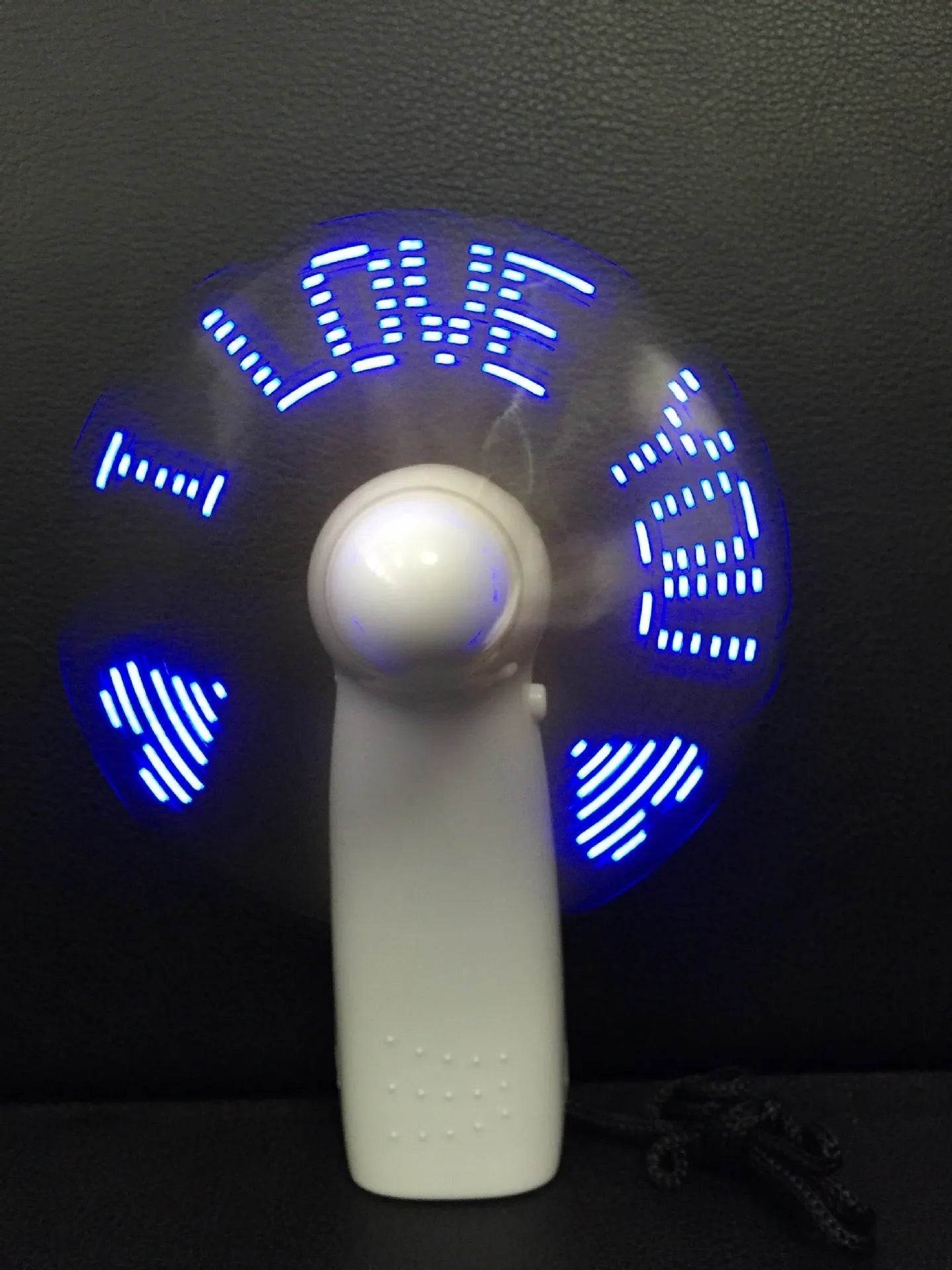 White handheld fan with LED love pattern display showing blue and red lights, measuring 10.8cm tall