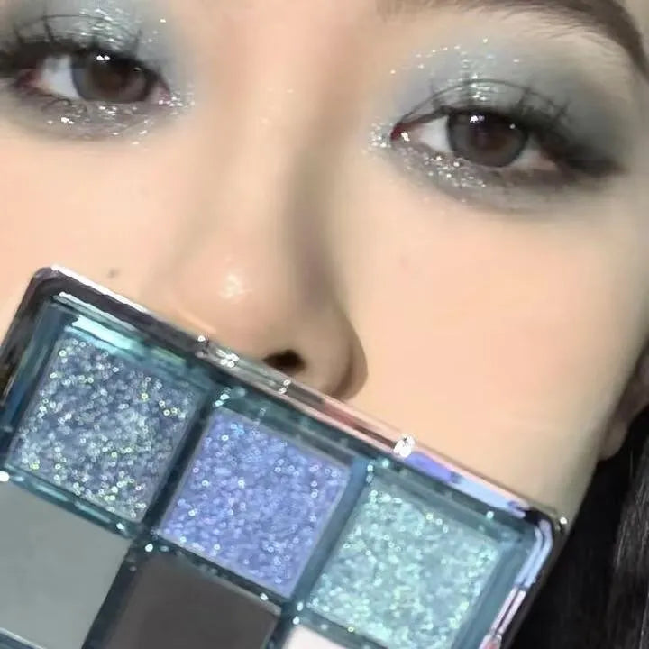 Low saturation blue smoked eye shadow palette with nine colours including matte and shimmer finishes with diamond debris textures