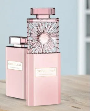 Pink coloured personal perfume fan with USB charging port for aroma diffusion.