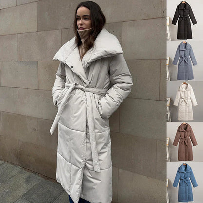 Cozy women's long winter coat with large lapel, lace-up design, and pockets for optimal warmth and style