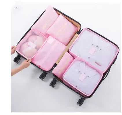 Set of six coloured nylon packing cubes and flat pouches for travel organisation.