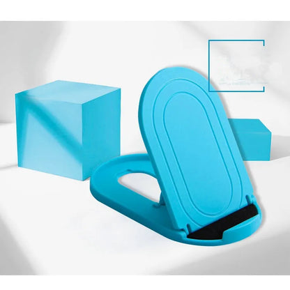 Black adjustable lazy bracket phone stand holding a mobile device at an angle on a wooden table.