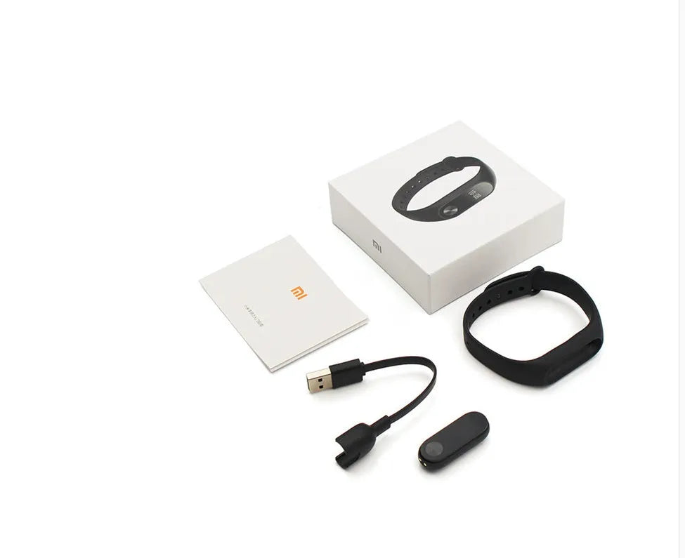 Xiaomi Mi Band 2 black fitness tracker with OLED display showing heart rate and time on adjustable wrist strap