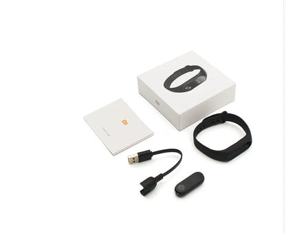 Xiaomi Mi Band 2 black fitness tracker with OLED display showing heart rate and time on adjustable wrist strap