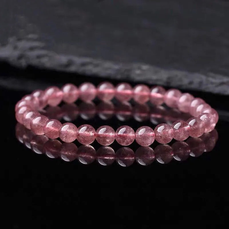 Women's strawberry quartz crystal bracelet with mixed 6mm, 8mm, and 10mm polished beads.