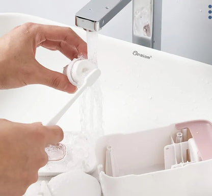 Automatic toothpaste dispenser with motion sensor and LED light in blue, grey or pink colours mounted on bathroom wall