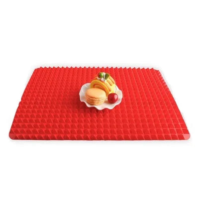 Red silicone pyramid grid cooking mat on a kitchen counter