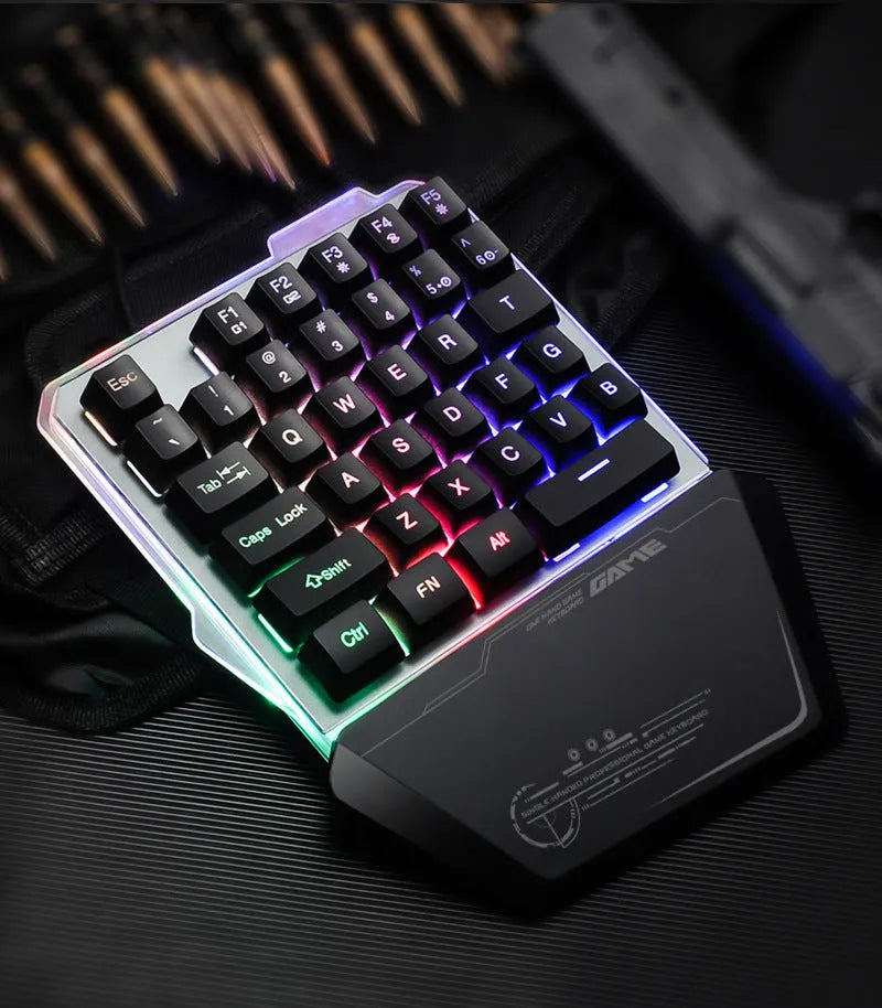 Black one-handed keyboard with RGB backlight and 1.8-metre USB cable on a desk