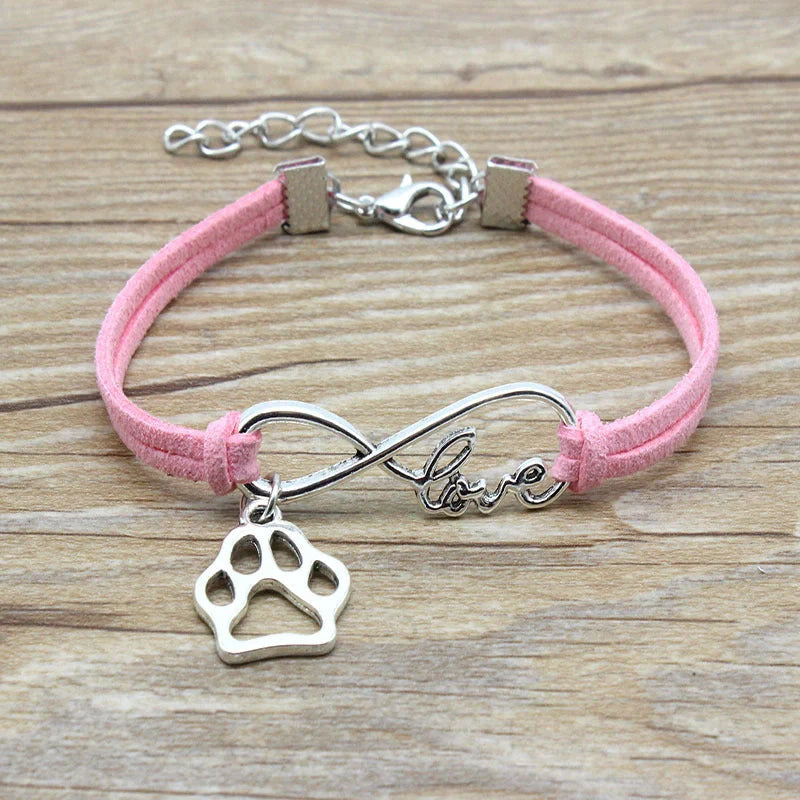 Hand-woven Infinite Love Pet Bracelet in various colors, showcasing the bow shape and alloy material.