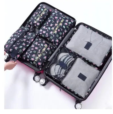 Set of six coloured nylon packing cubes and flat pouches for travel organisation.