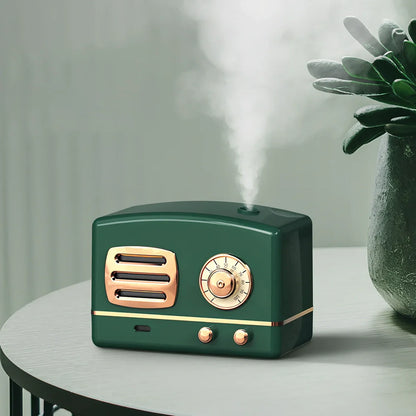 Green retro humidifier with bronzing finish measuring 9.5cm tall on wooden desk