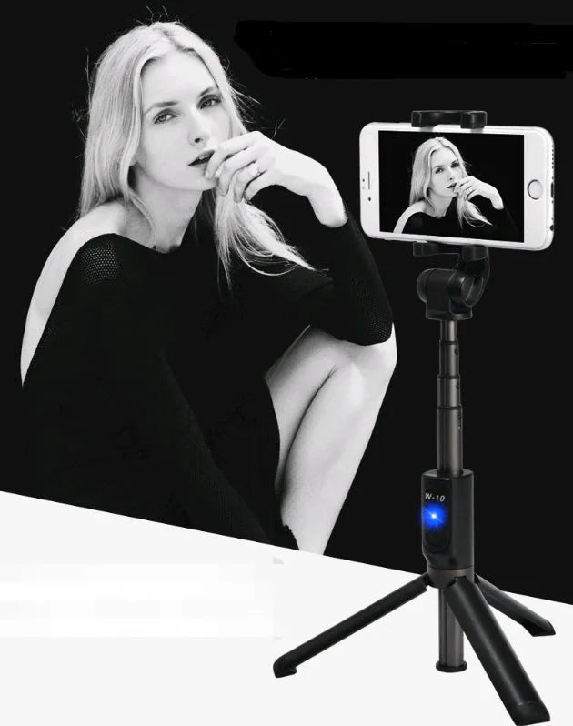 Black aluminium Bluetooth selfie stick with tripod legs extended, holding a smartphone.