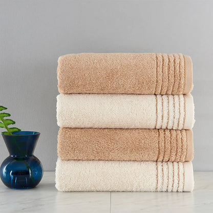 Beige and brown cotton towel set showing bath, hand, and face towel sizes.