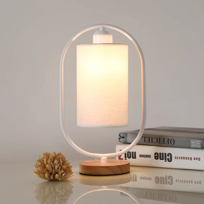 Black metal bedside lamp with dimming button and 5W LED warm light on wooden table