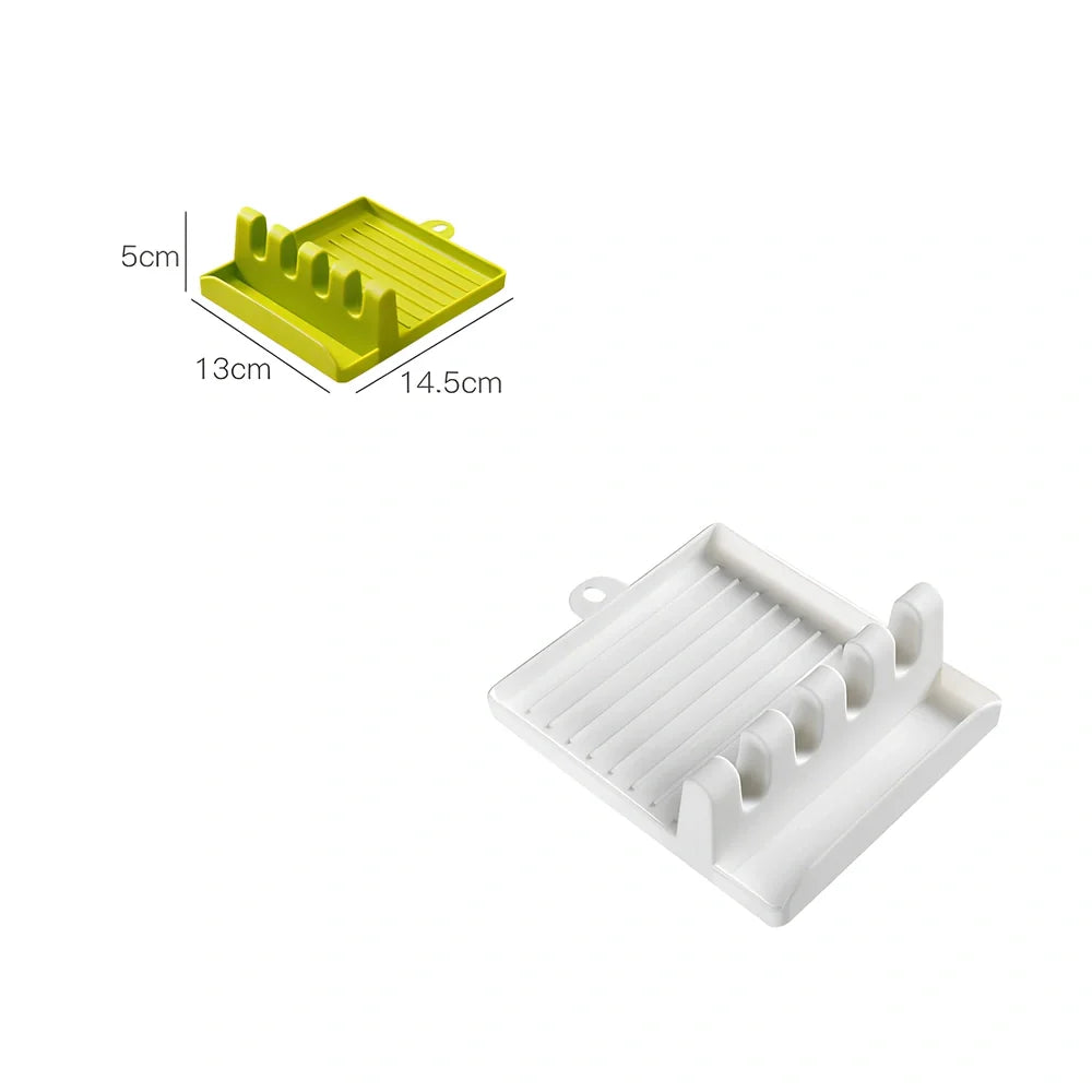 Green silicone spatula holder with four slots for kitchen utensils on countertop
