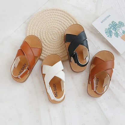 Children's black cross-strap sandals with adjustable Velcro fastening showing size range 21-30