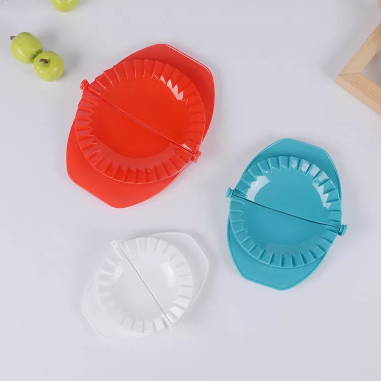 Plastic dumpling maker device in blue, green, and white for quick, uniform dumplings