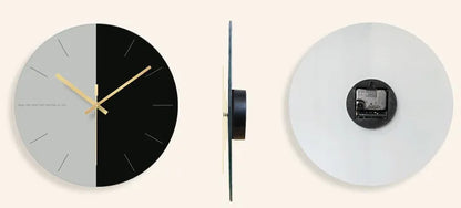 A large, clear tempered glass wall clock with a minimalist transparent face on a light background.