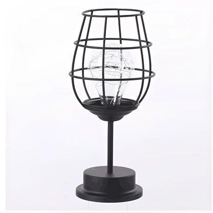 Minimalist hollow table lamp in red wine bottle design with wrought iron construction and warm white LED illumination