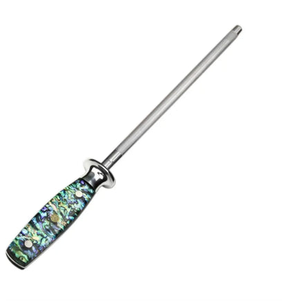 Household knife sharpener with high carbon steel blade and abalone shell handle on a kitchen counter.