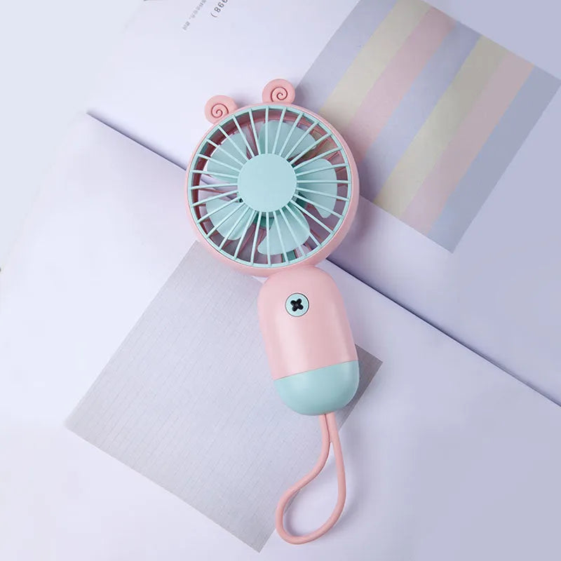 Handheld portable mini fan in green, pink, purple, or white, made from ABS and silicone with 500mAh battery