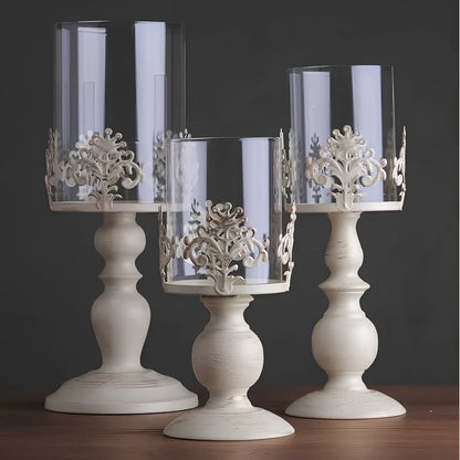 Iron candle holder with birdcage design measuring 37cm height and carved glass version at 33cm