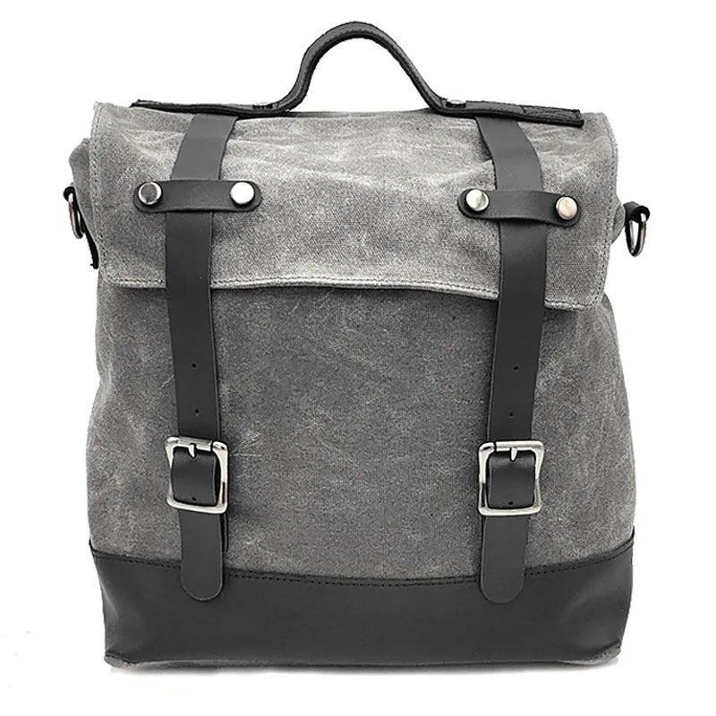 Black waterproof canvas motorcycle side bag with cowhide accents showing mounting straps