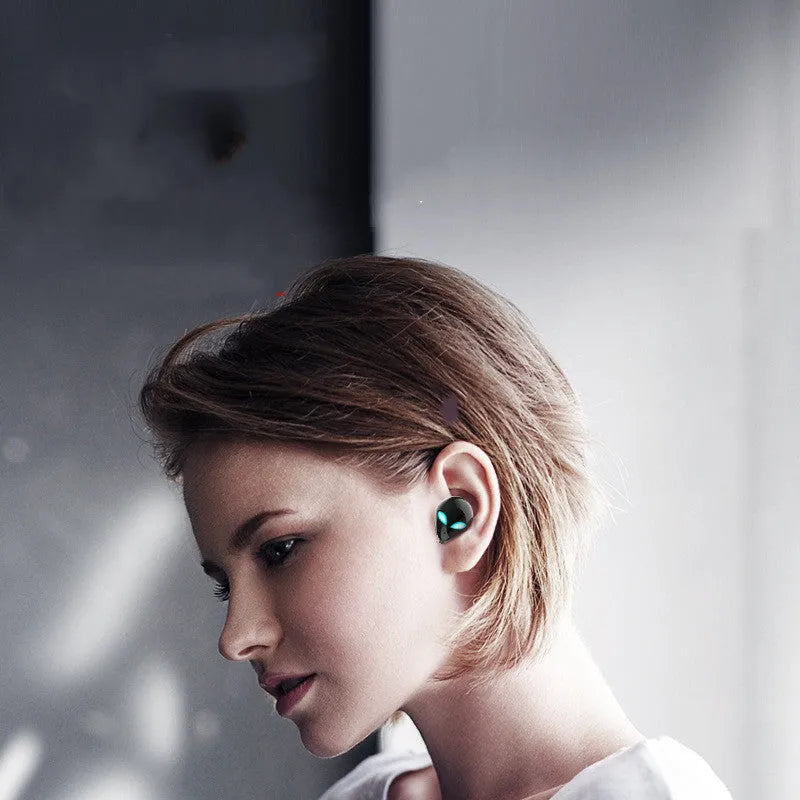 Creative Outer T8 Starman alien design Bluetooth headset and charging case in black or white.