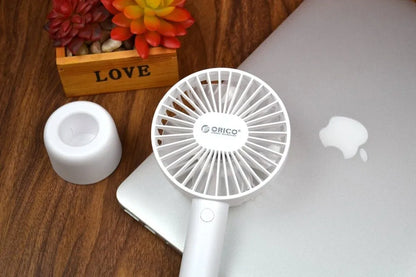 White ORICO FH1 portable USB desk fan with rechargeable battery on a wooden desk