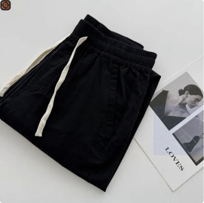 Men's loose straight casual pants with drawstring waist in navy blue colour, showing relaxed fit and straight leg design
