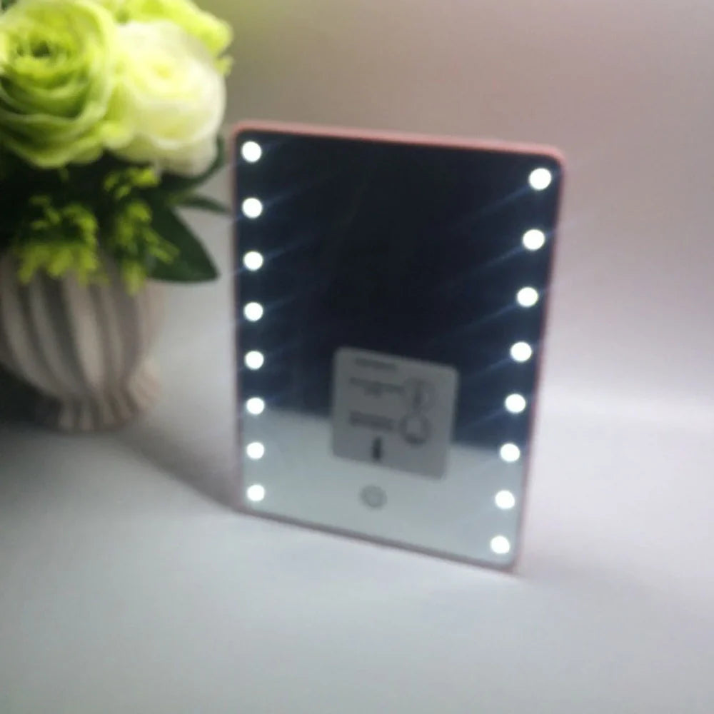 Black LED makeup mirror with 16 lights around 225mm × 165mm frame on dressing table