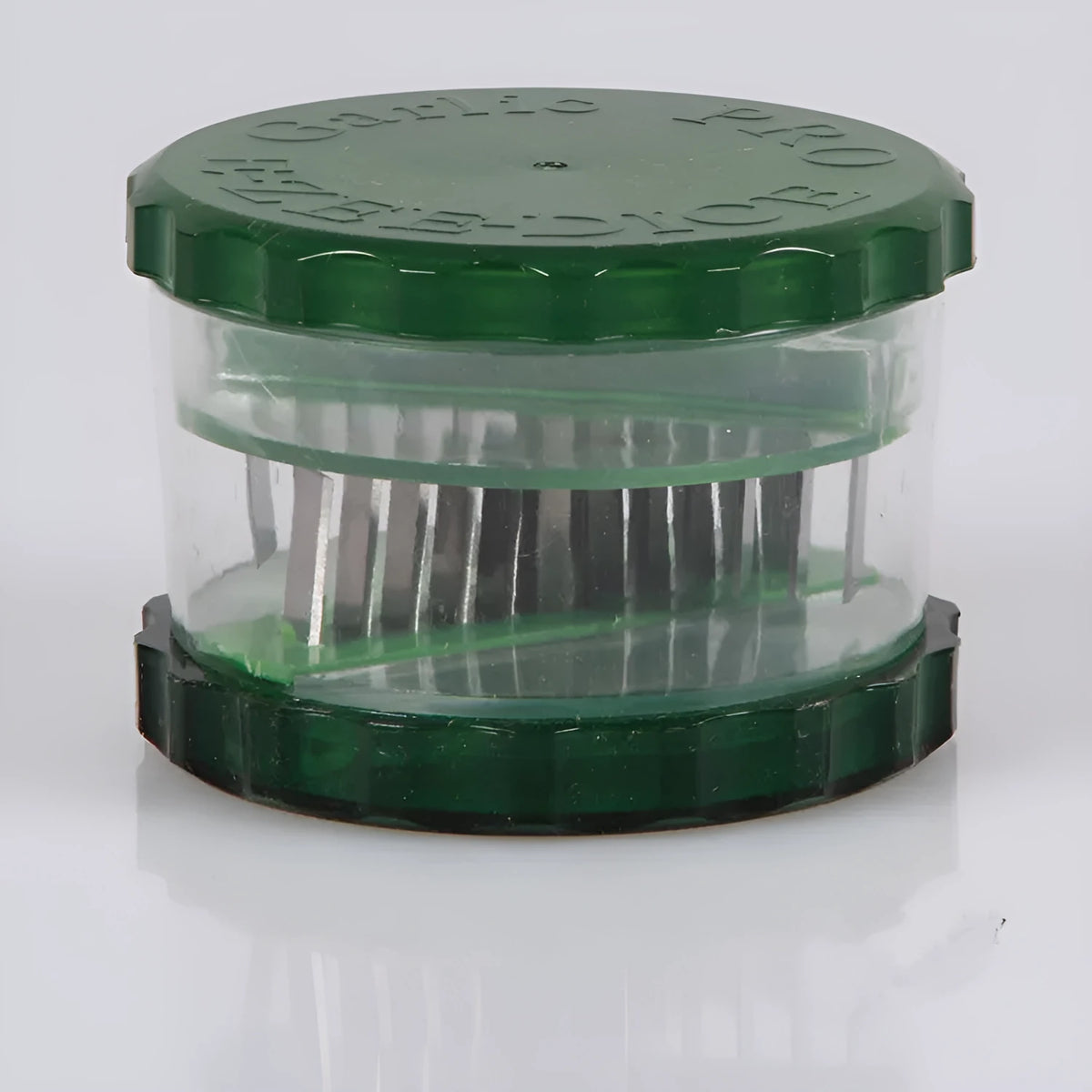 Green manual garlic peeler kitchen tool with silicone roller and plastic press handle.