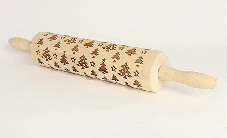 Wooden rolling pin with engraved Christmas patterns including reindeer and snowflakes on a 45cm long barrel.