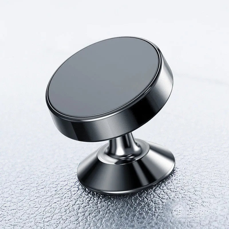 Magnetic car phone holder with aluminium alloy CD-textured base attached to a car air vent, holding a smartphone.