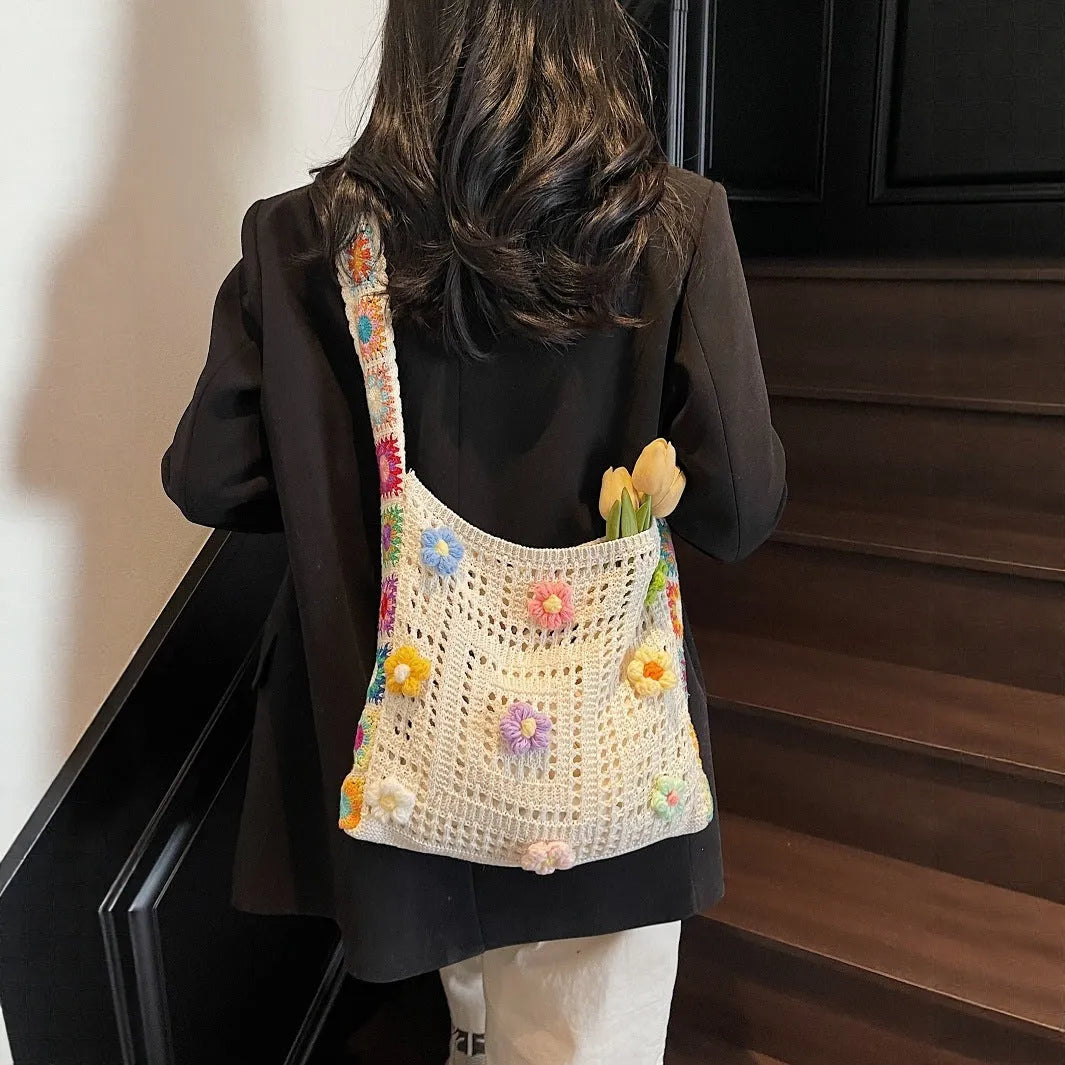 Woven polyester shoulder bag showing hollow knitting texture and single 41cm strap in neutral colour