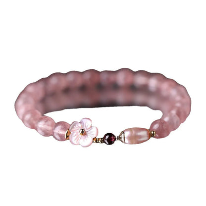 Strawberry quartz peach blossom crystal bracelet for women showing floral design.