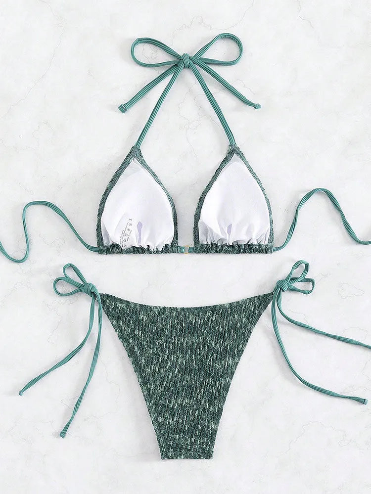 Women's green halterneck swimsuit with backless design and matching shorts