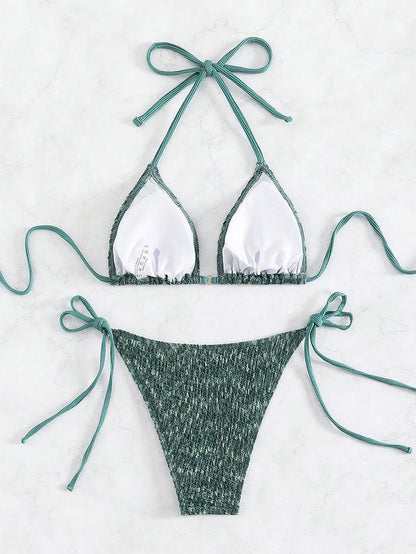 Women's green halterneck swimsuit with backless design and matching shorts