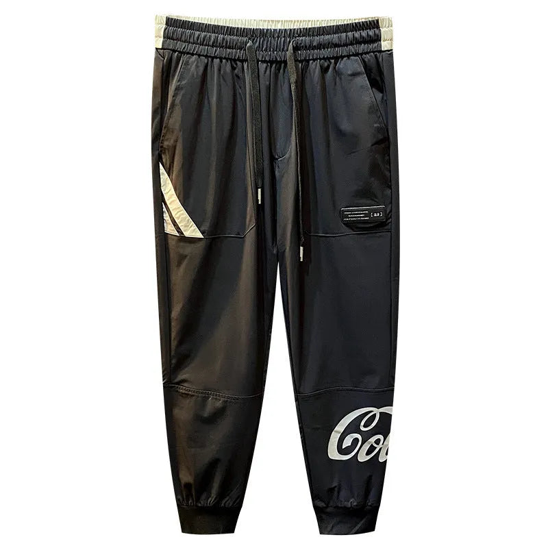 Black men's casual cotton trousers with a cropped, ankle-banded leg design on a neutral background.