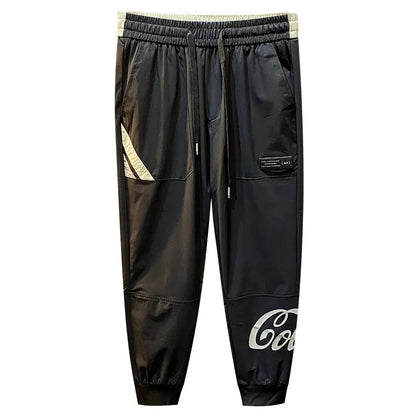 Black men's casual cotton trousers with a cropped, ankle-banded leg design on a neutral background.