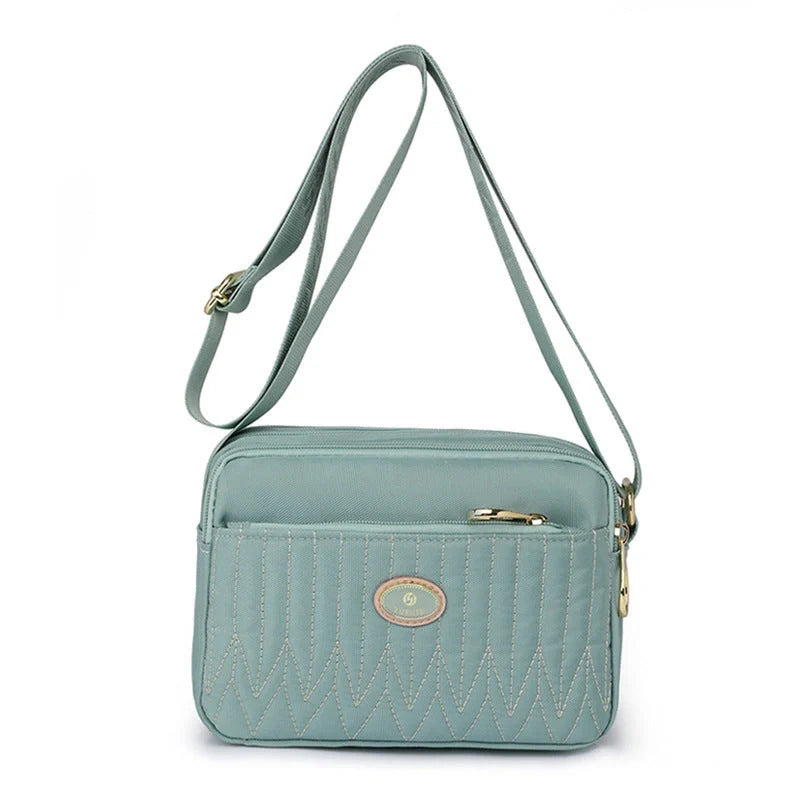 Casual women's crossbody messenger bag in nylon with polyester lining, available in multiple colors