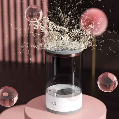 Grey and white portable electric makeup brush cleaner with USB charging cable.