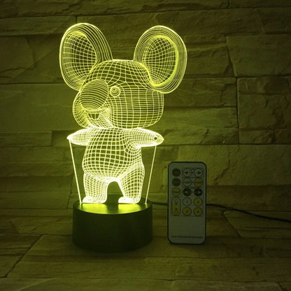 Black Koala night light with LED illumination on a bedside table.